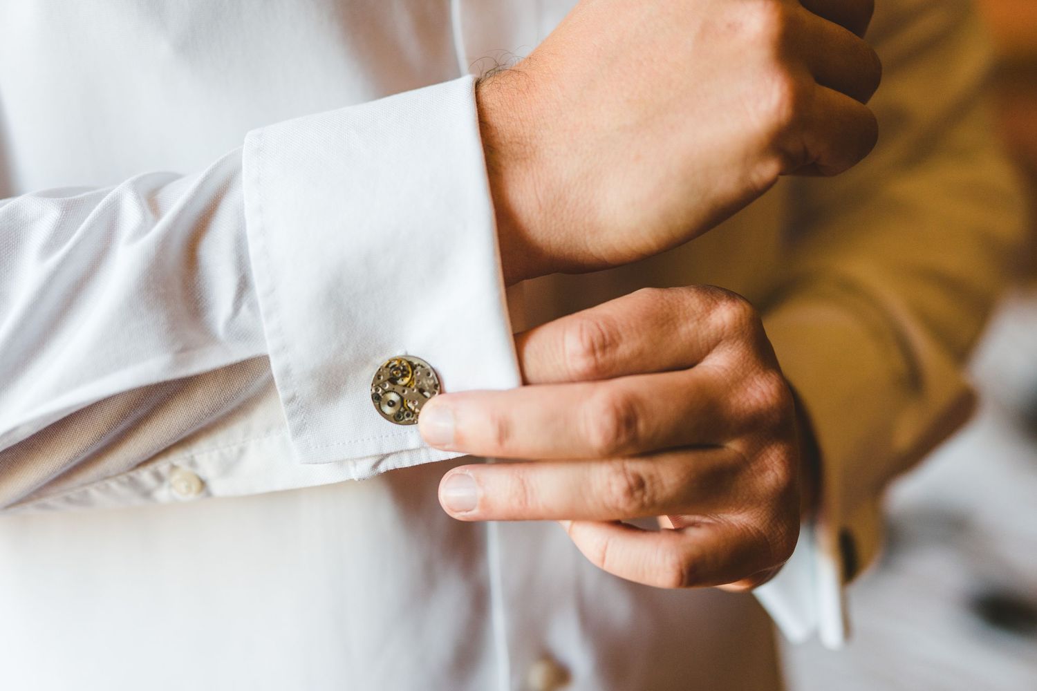 Close-up details of wedding rings being exchanged during ceremony.