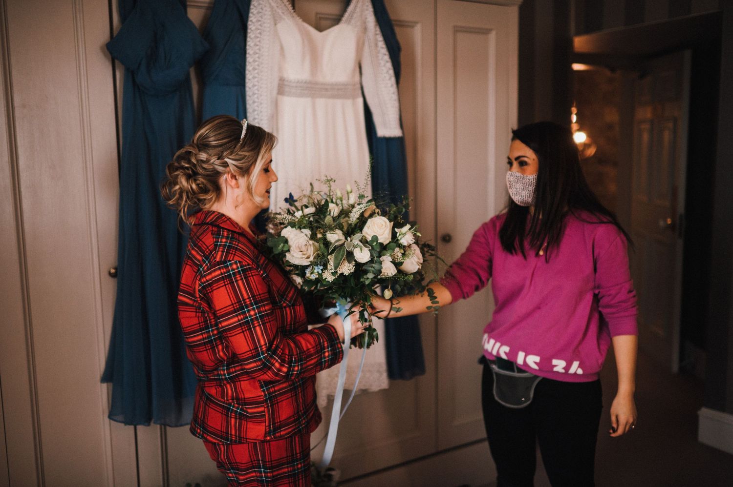 Wedding preparation scene with floral arrangement and casual attire.