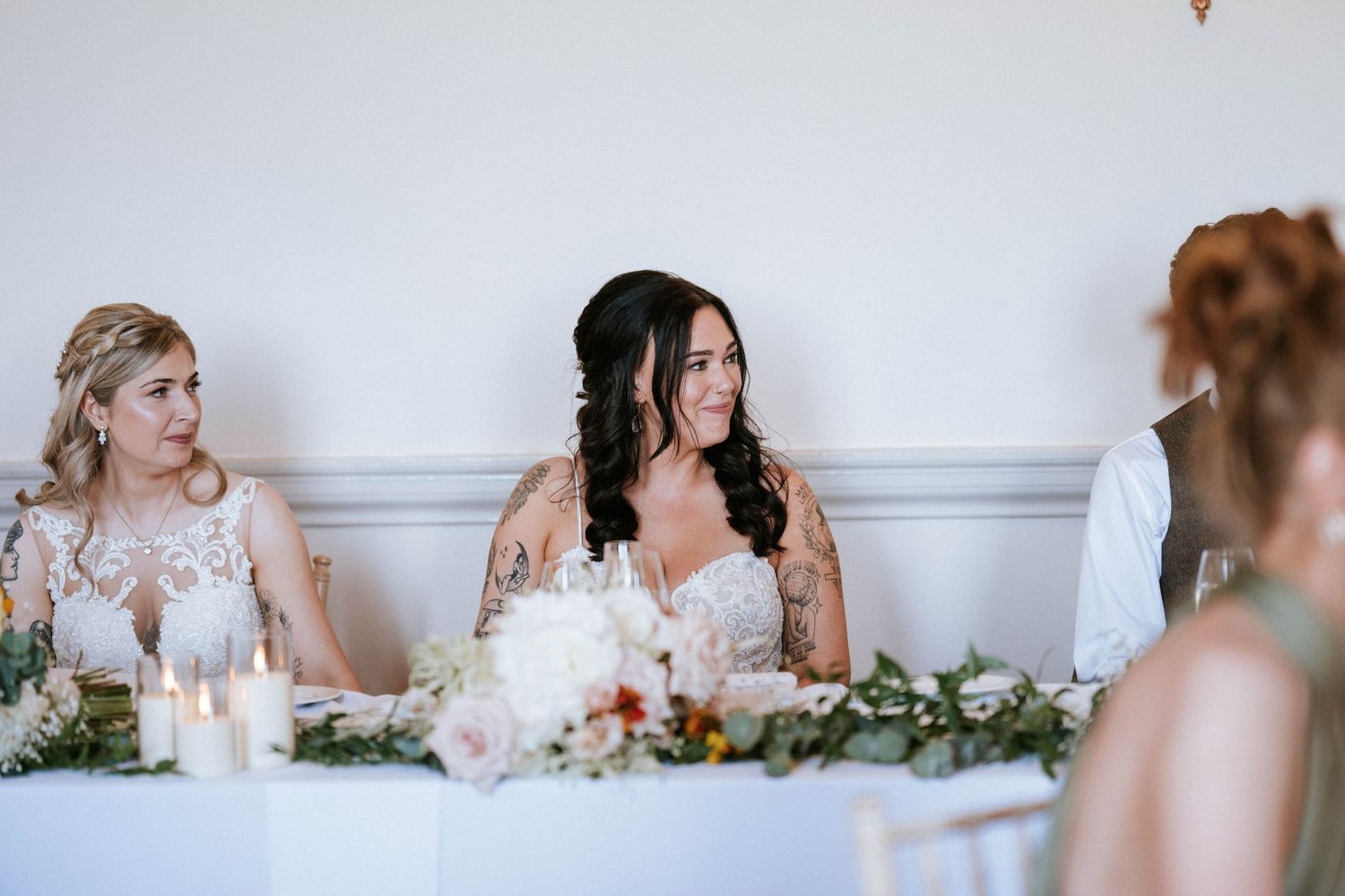 Wedding reception guests seated at tables during dinner service.