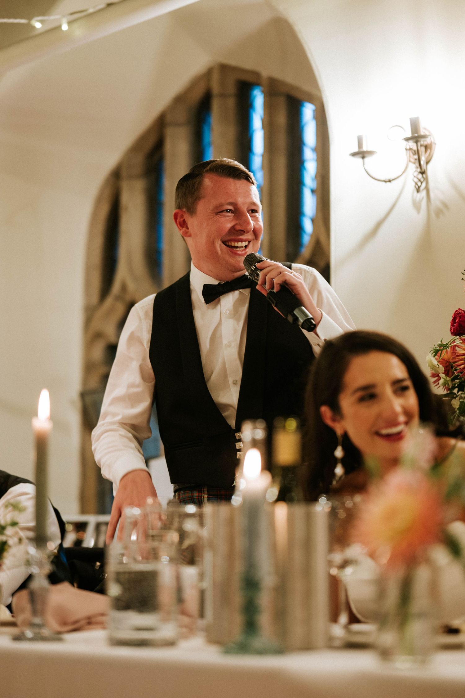 Wait staff serving guests during an elegant indoor wedding reception.