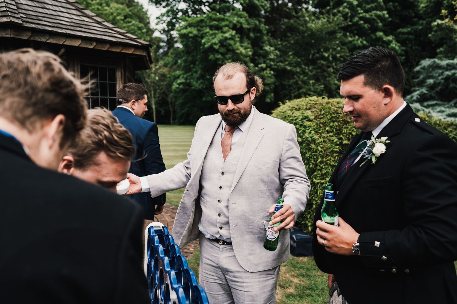 Wedding guests playing outdoor lawn games in colorful dresses.