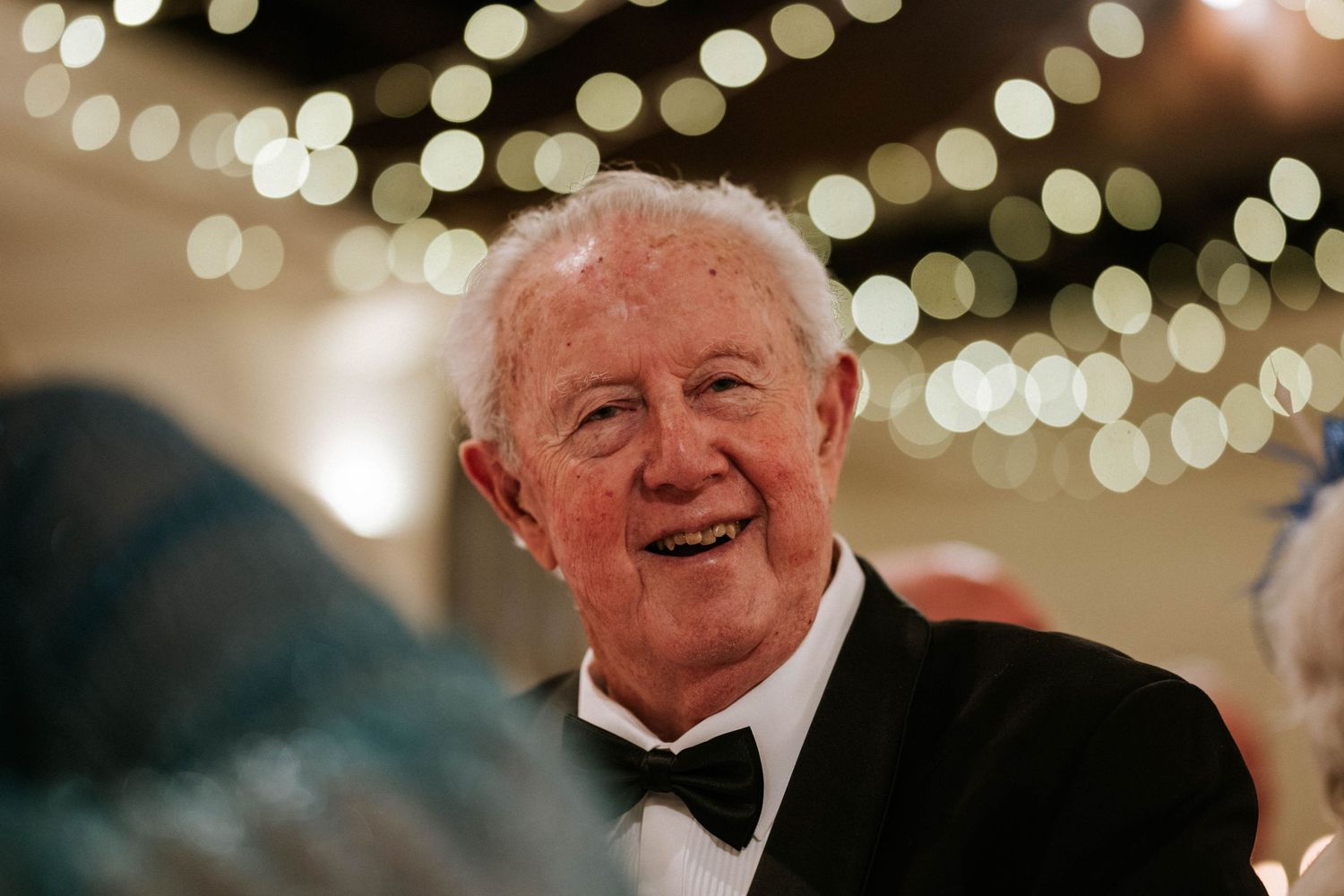Aberdeen Wedding Photography. Reception venue decorated with warm bokeh lighting creates festive atmosphere.