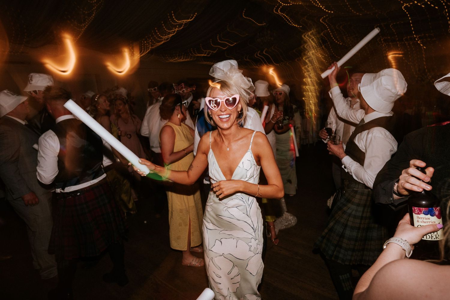 Aberdeen Wedding Photography. Lively dance floor celebration at an evening wedding reception with string lights.