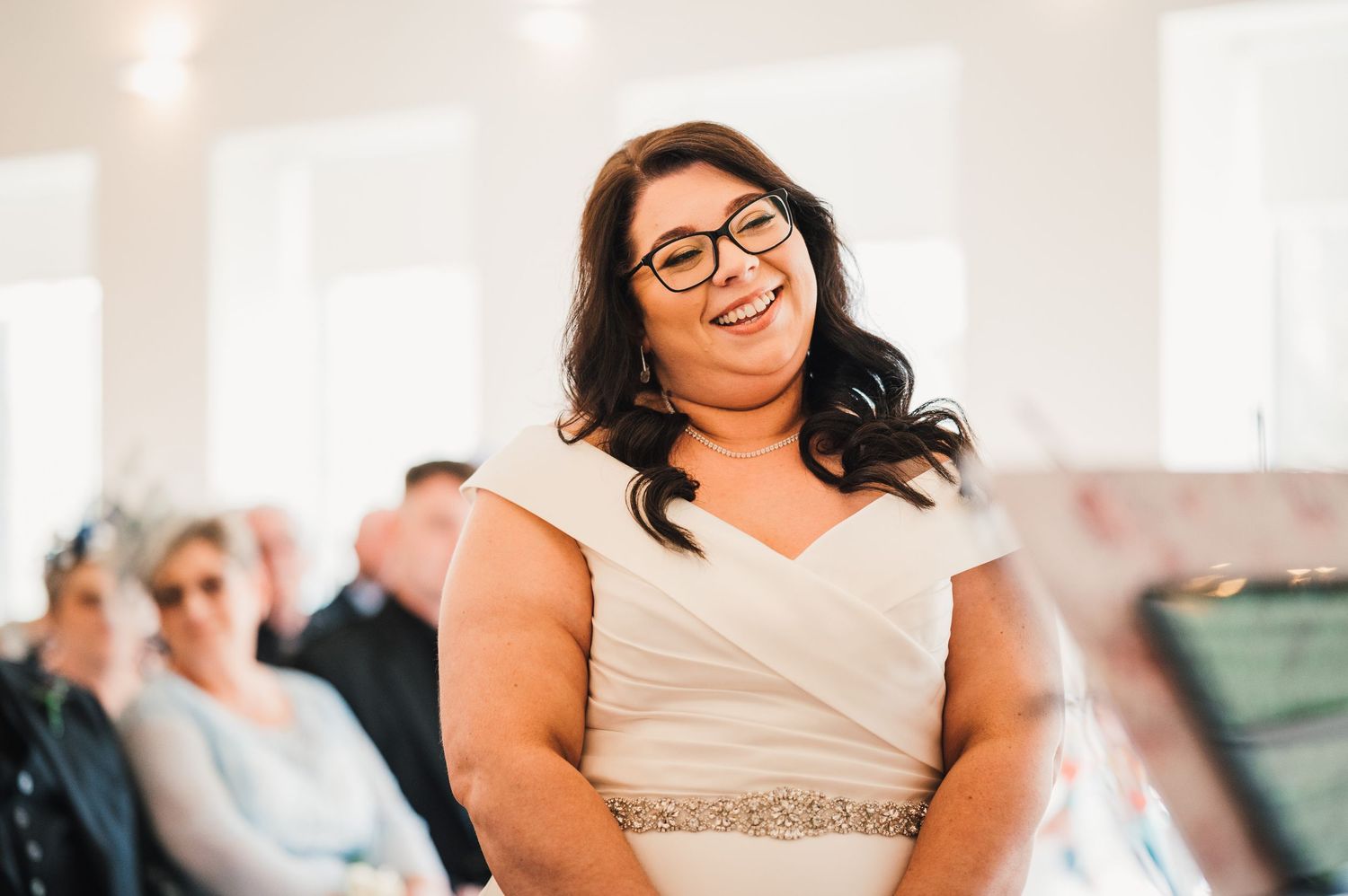 Logie House Wedding Photography. Joyful moments during a wedding reception with white decor and string lights.