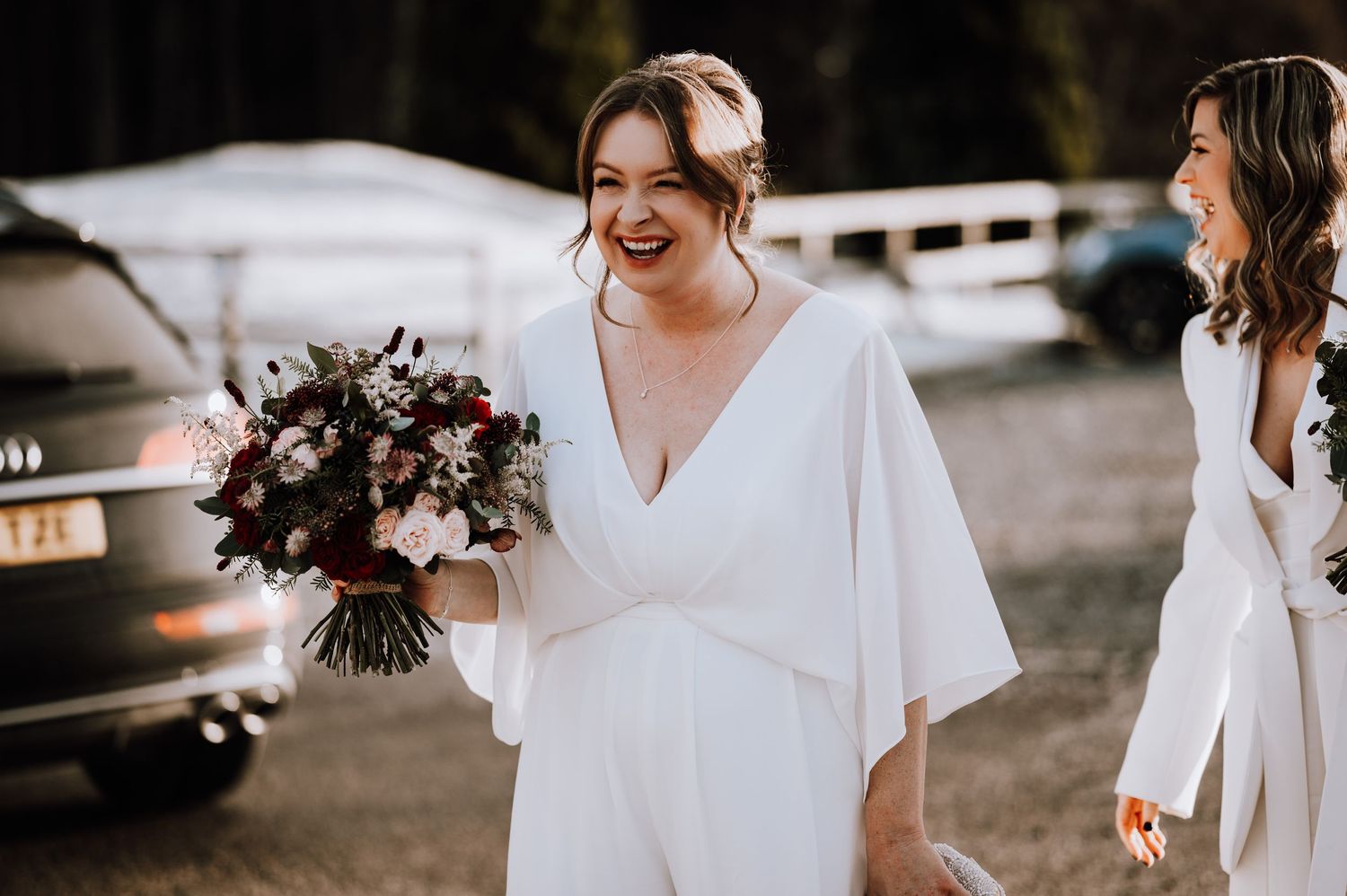Same Sex Wedding Photography. Wedding party members in white and black attire gather outdoors for group photos.