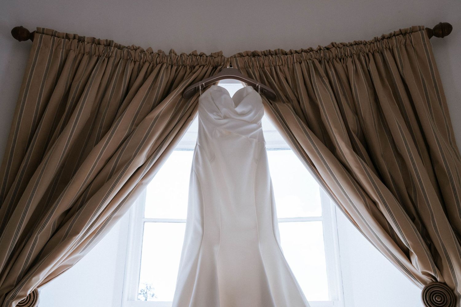 Elegant taupe curtains framing tall windows in a classic castle interior.