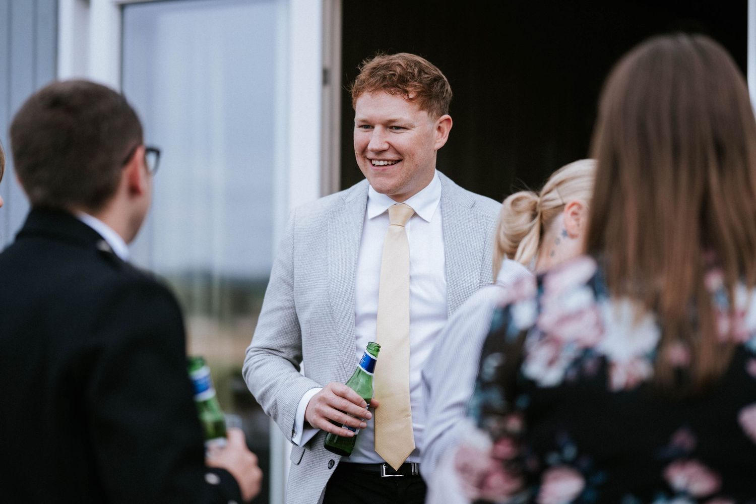 Wedding guests mingling and socializing during outdoor reception.
