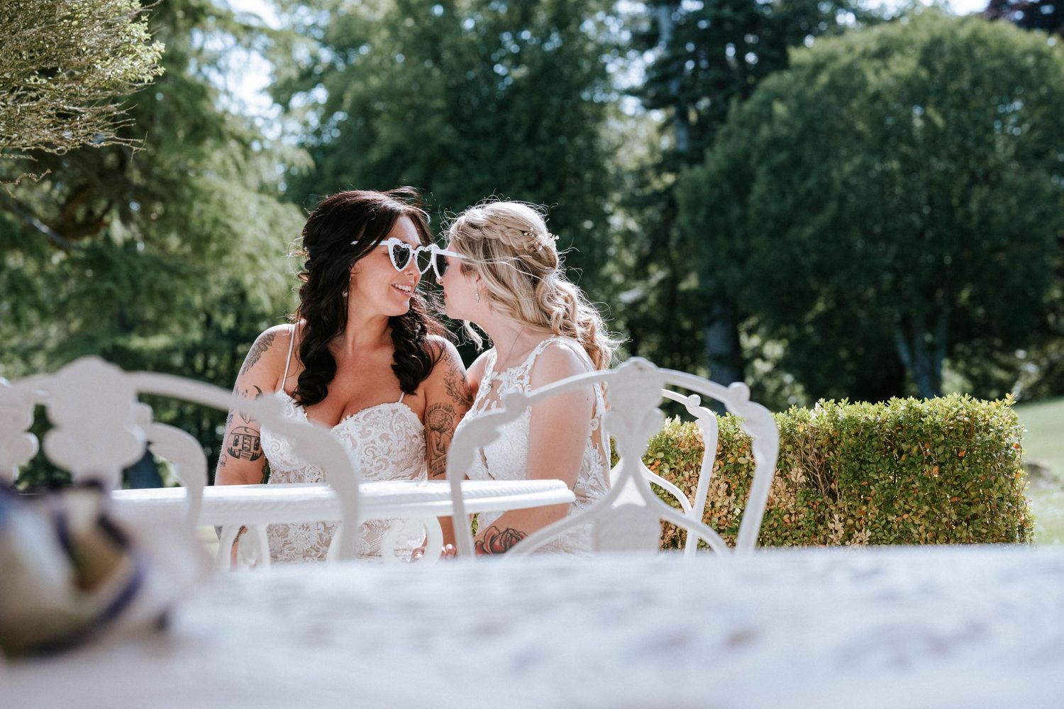 Wedding couple sharing intimate moments at an outdoor reception with string lights.