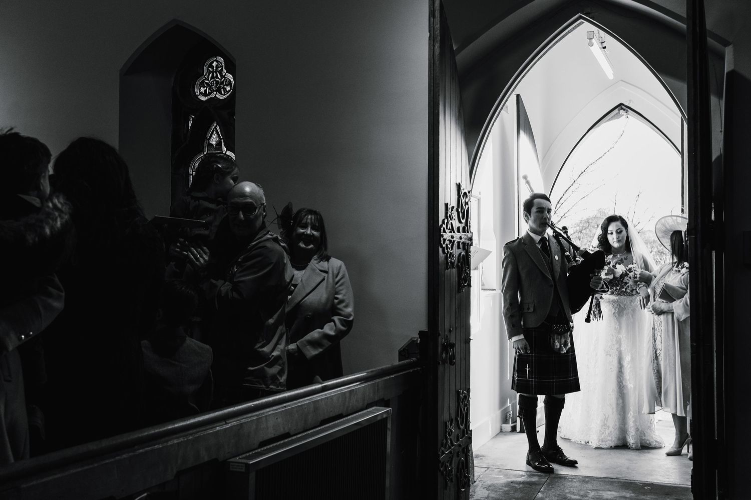 Aberdeen Wedding Photography. Dramatic black and white wedding ceremony captured through church archways.