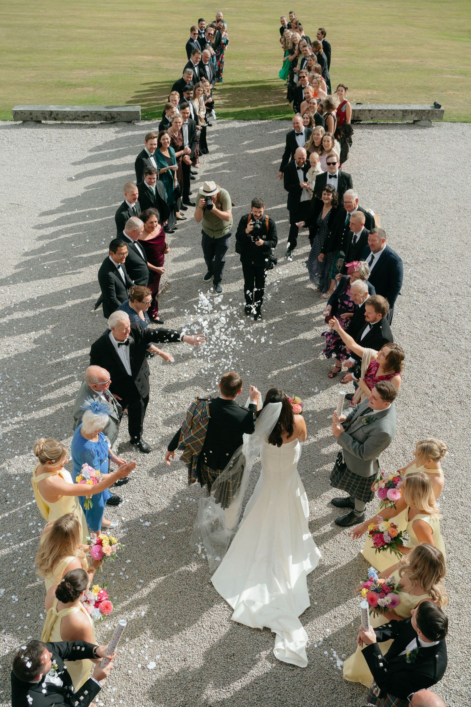 A sequence of photos showing wedding guests tossing confetti at a couple walking down outdoor stone steps.