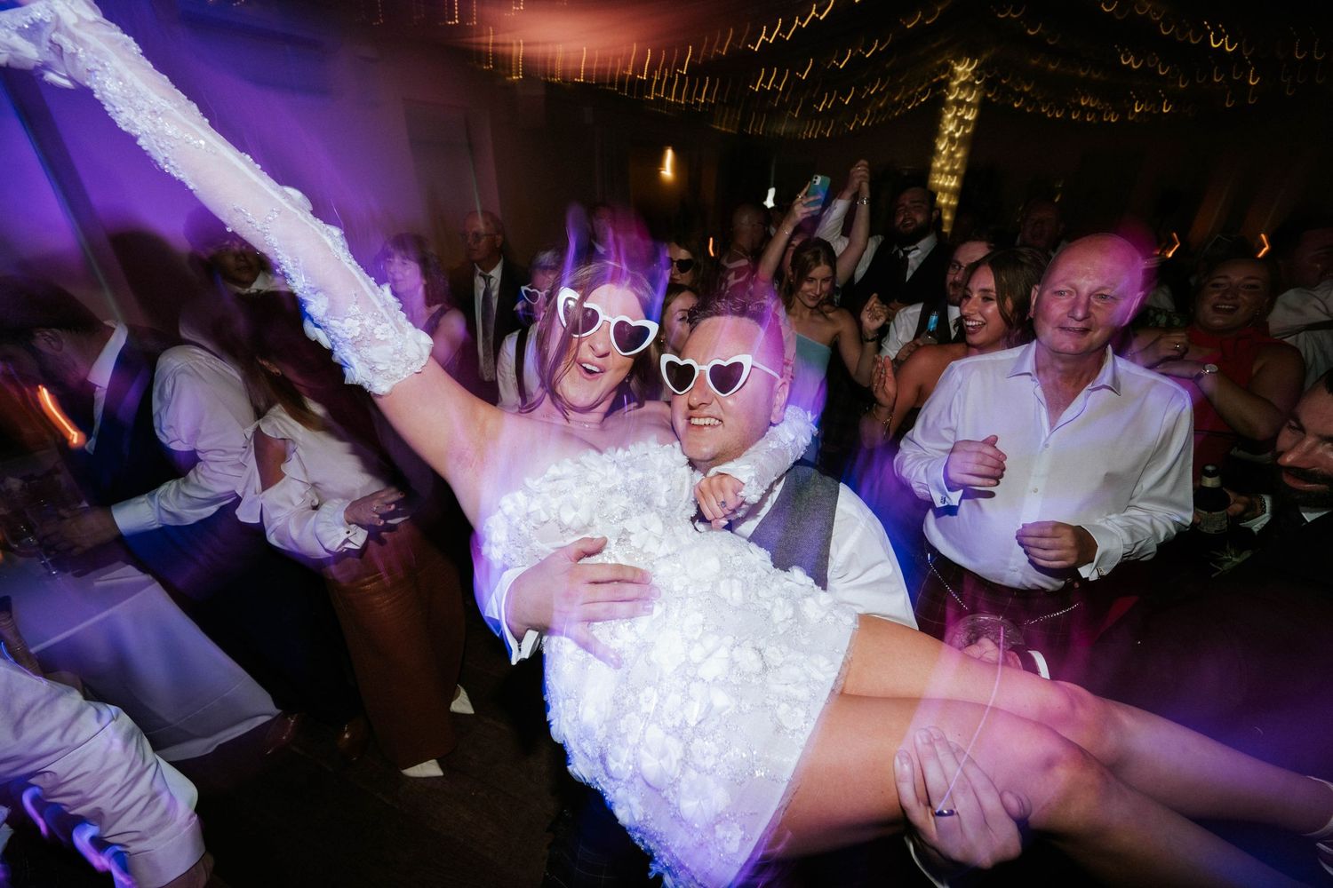 Aberdeen Wedding Photography. Wedding reception party with colorful lighting and energetic dancing.