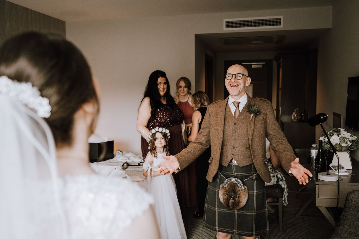 Wedding party reacts emotionally during first look reveal in indoor venue Meldrum House Wedding Photography.