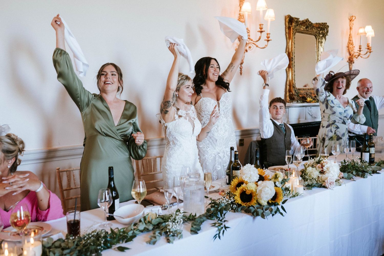 Fasque Castle Wedding Photography. Wedding reception celebration with guests standing and raising glasses for a toast.