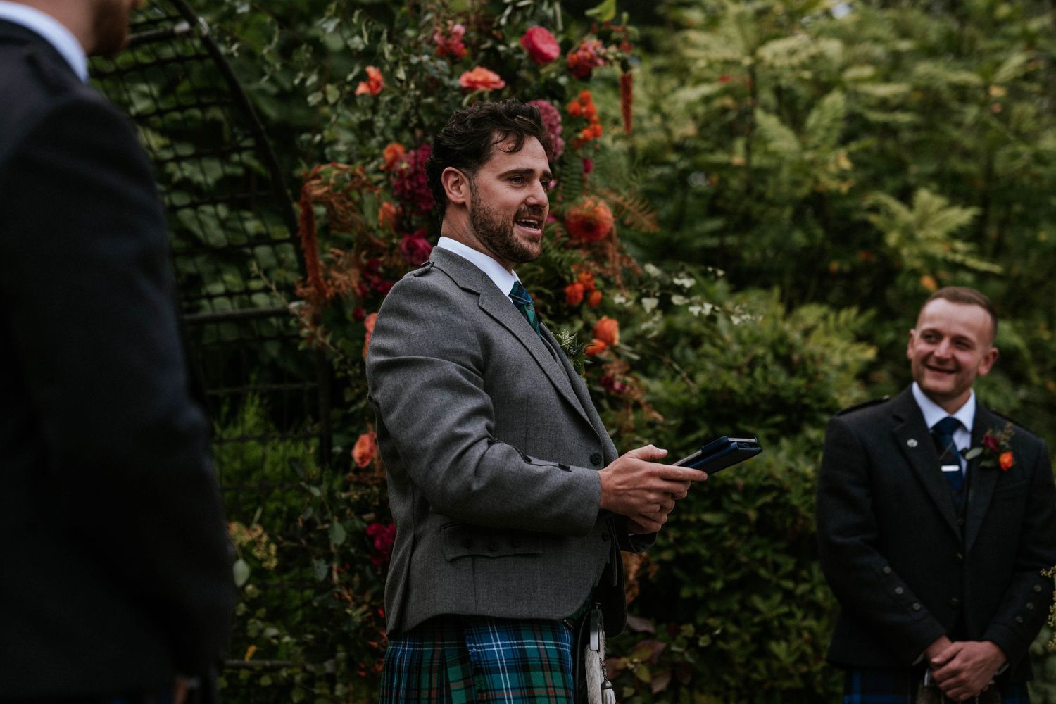Wedding party gathering in a garden with beautiful autumn flowers.