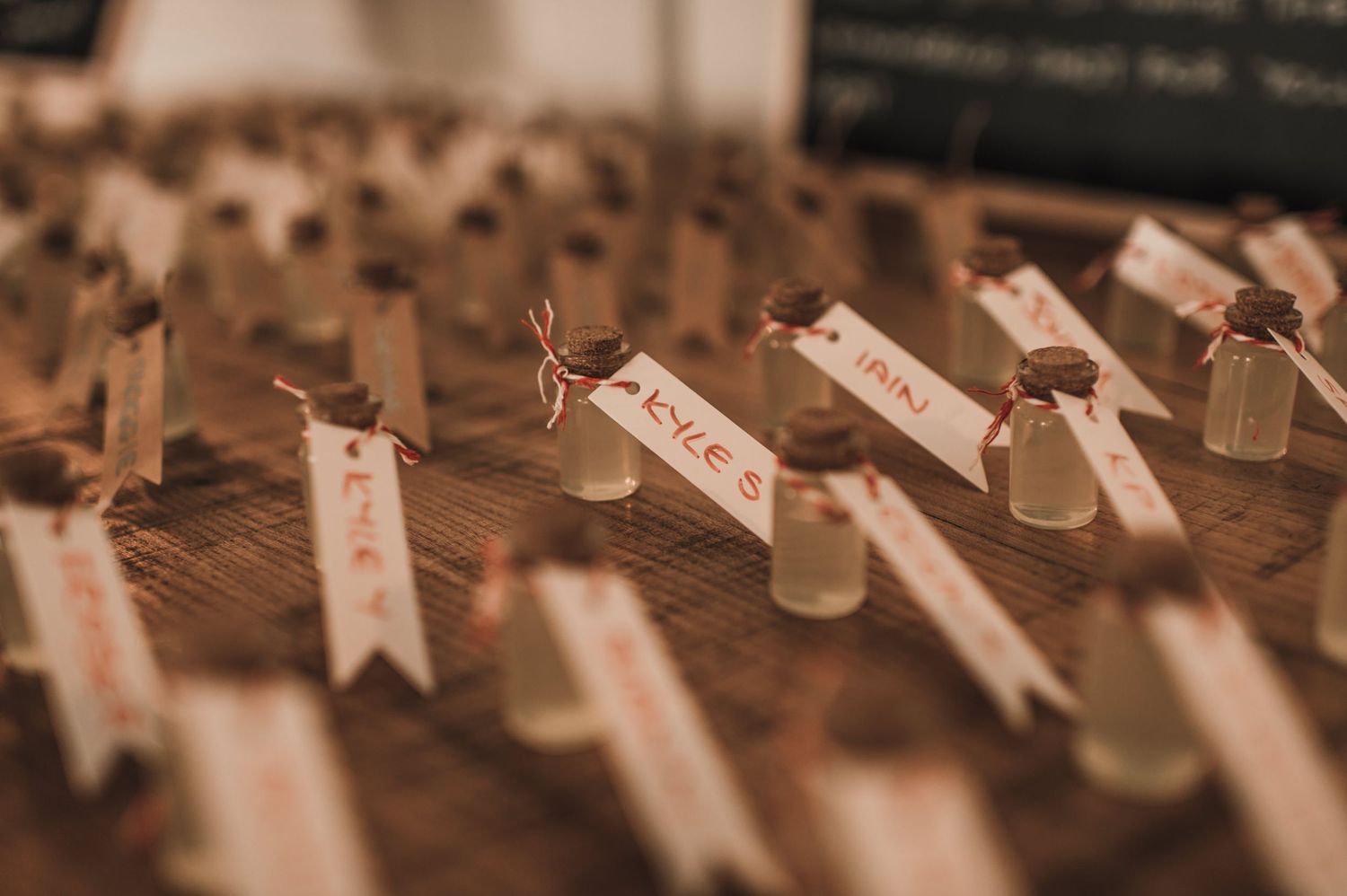 Wedding place cards arranged in neat rows with small wooden decorative elements.