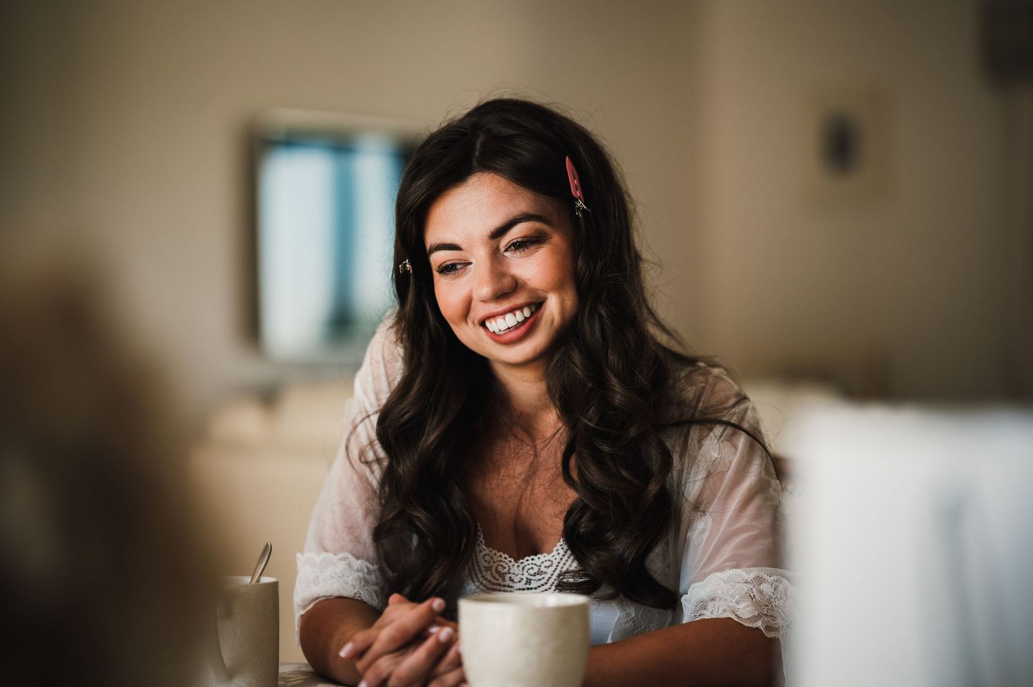 A warm moment captured over coffee during wedding preparation festivities.