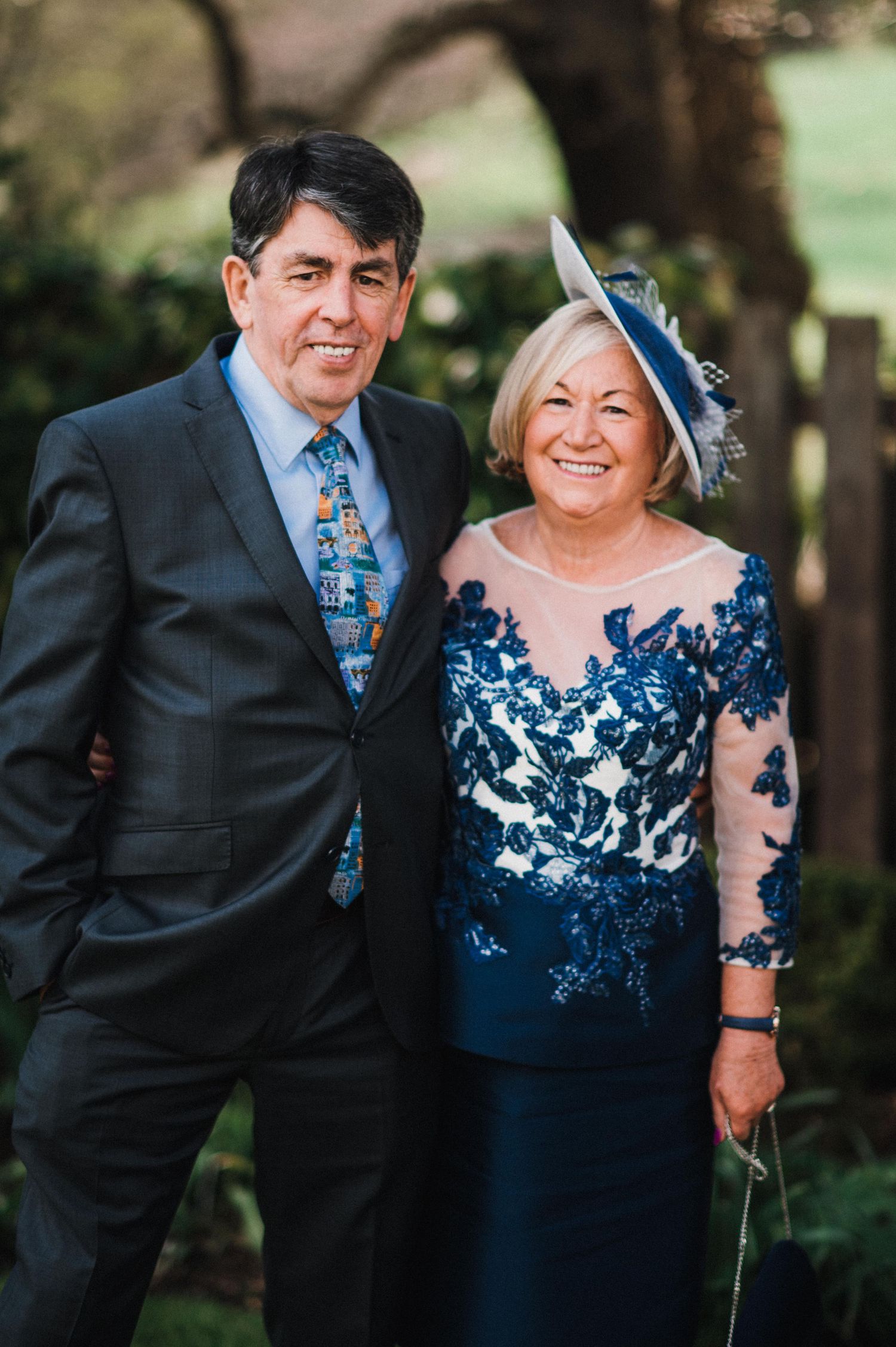 Formal event attendees in elegant blue and black attire.
