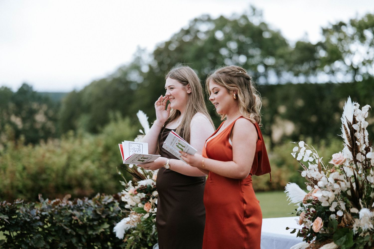 Wedding guests in autumn colors enjoying refreshments during an outdoor celebration.