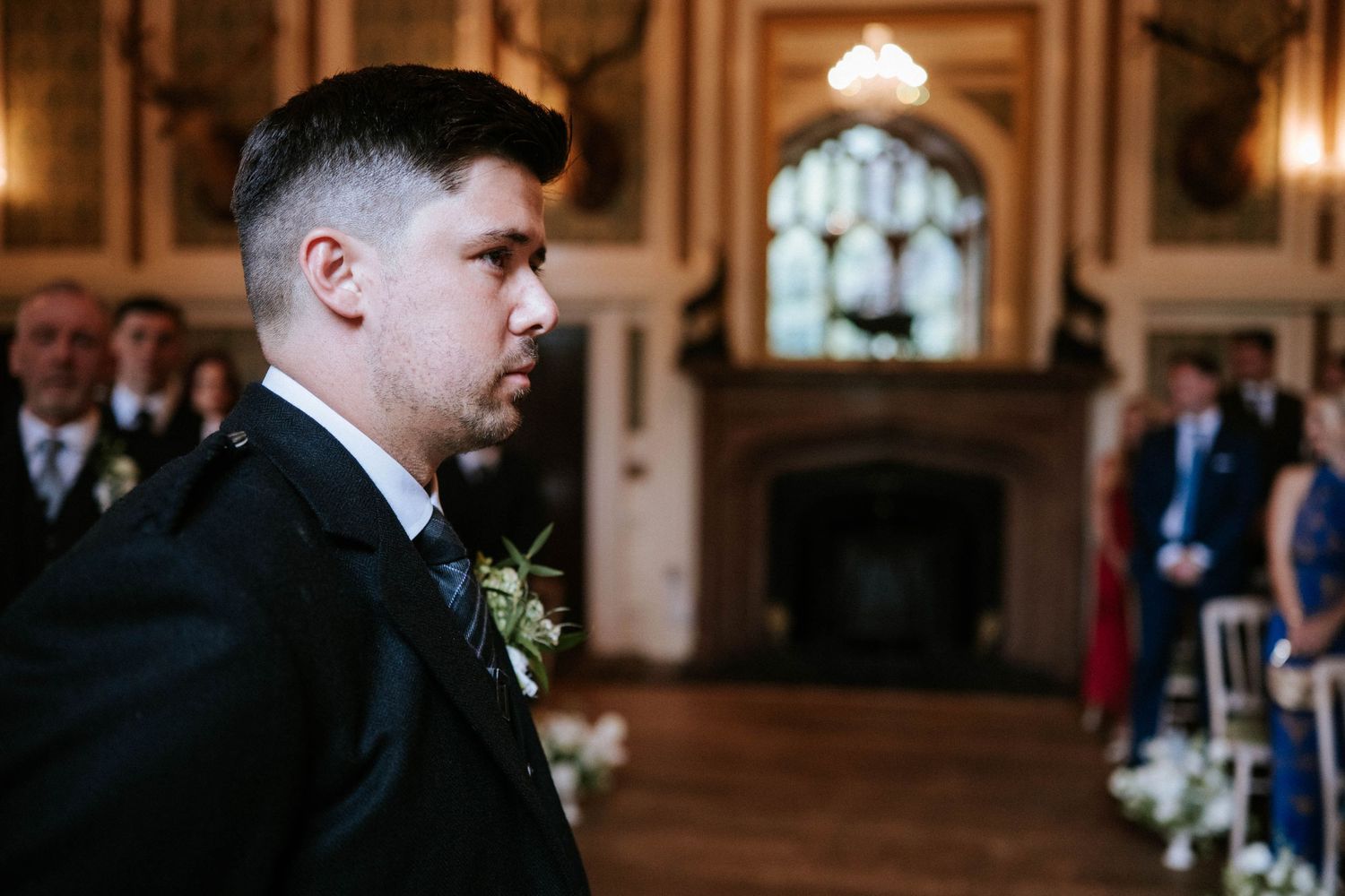 Elegant wedding ceremony venue with pink walls and ornate architectural details.