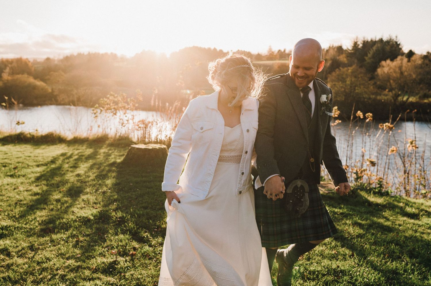 Golden hour wedding photography by a lake with Scottish elements.
