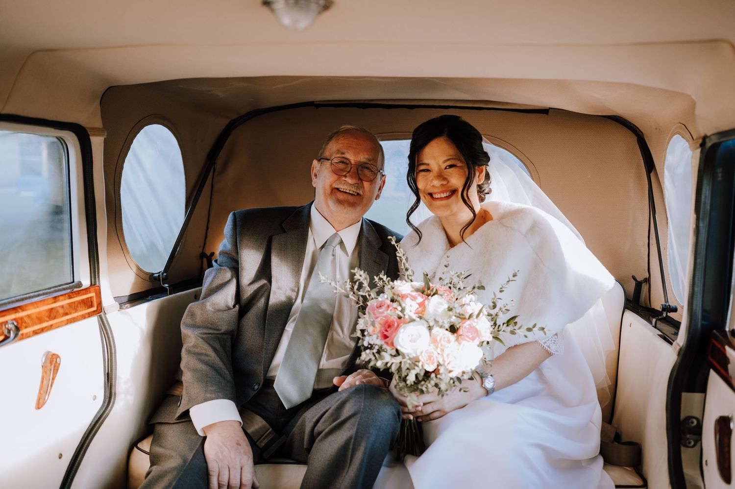 A joyful moment captured inside a wedding car with beautiful floral bouquet.