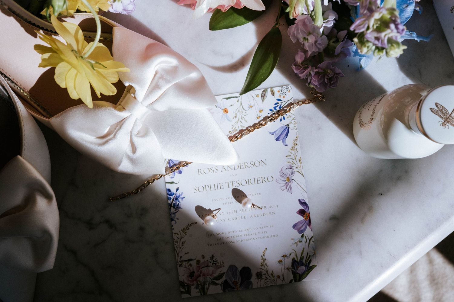 Wedding dress details with delicate floral decorations and soft natural lighting.