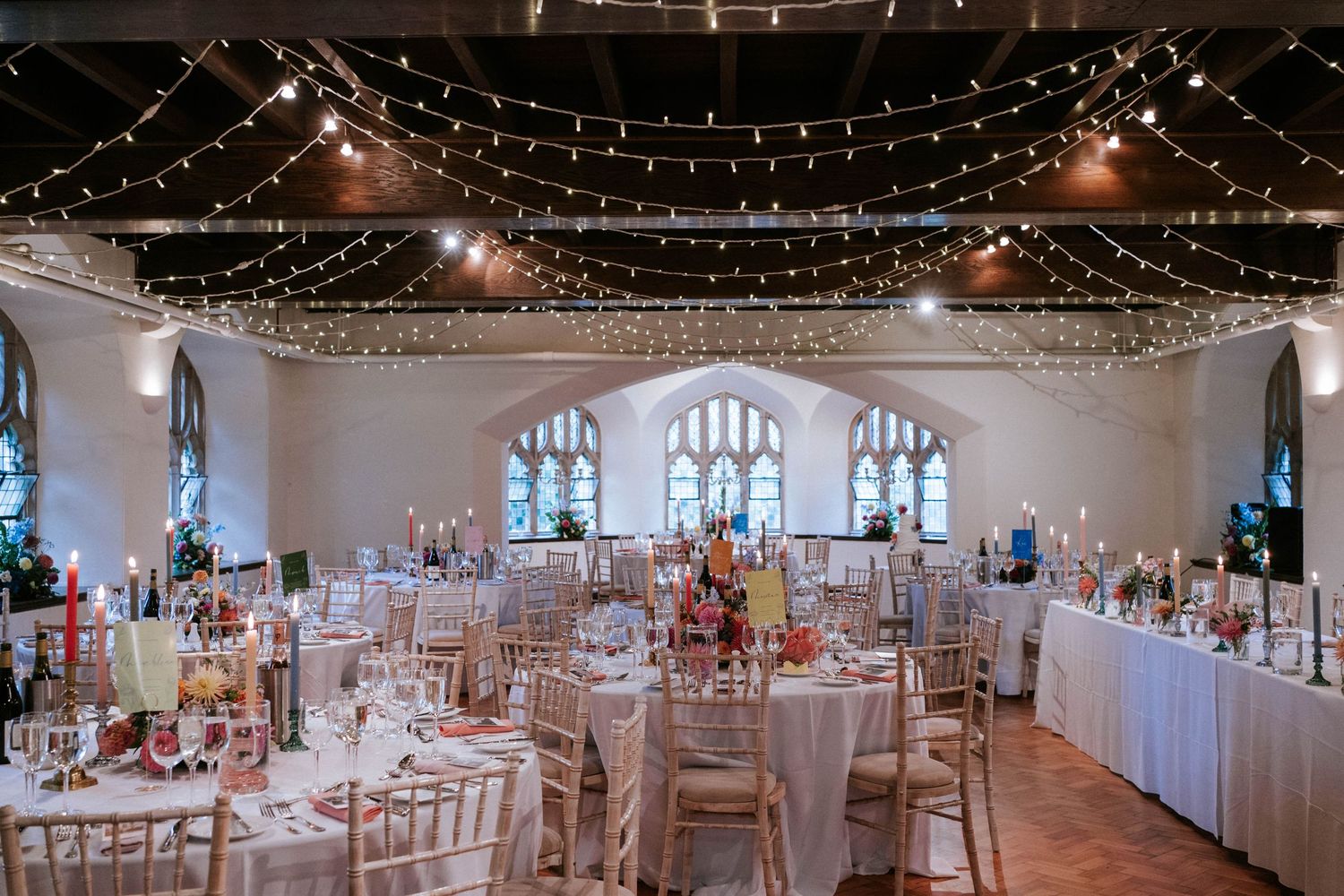Wedding reception venue with twinkling fairy lights and elegant table settings.