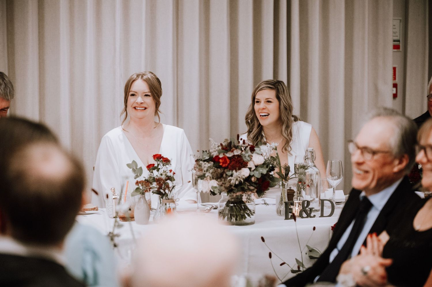 Same Sex Wedding Photography. Wedding reception dinner setup with elegant table settings and romantic mood lighting.
