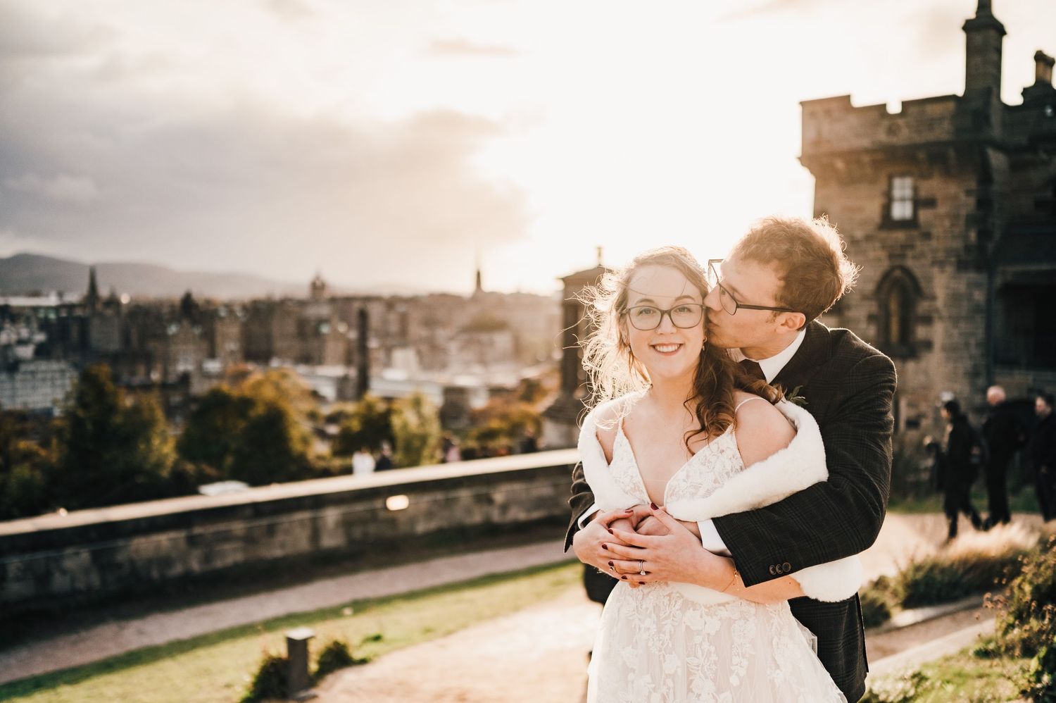 Aberdeen Wedding Photography. Wedding couple shares tender moments at sunset with panoramic city views behind them.