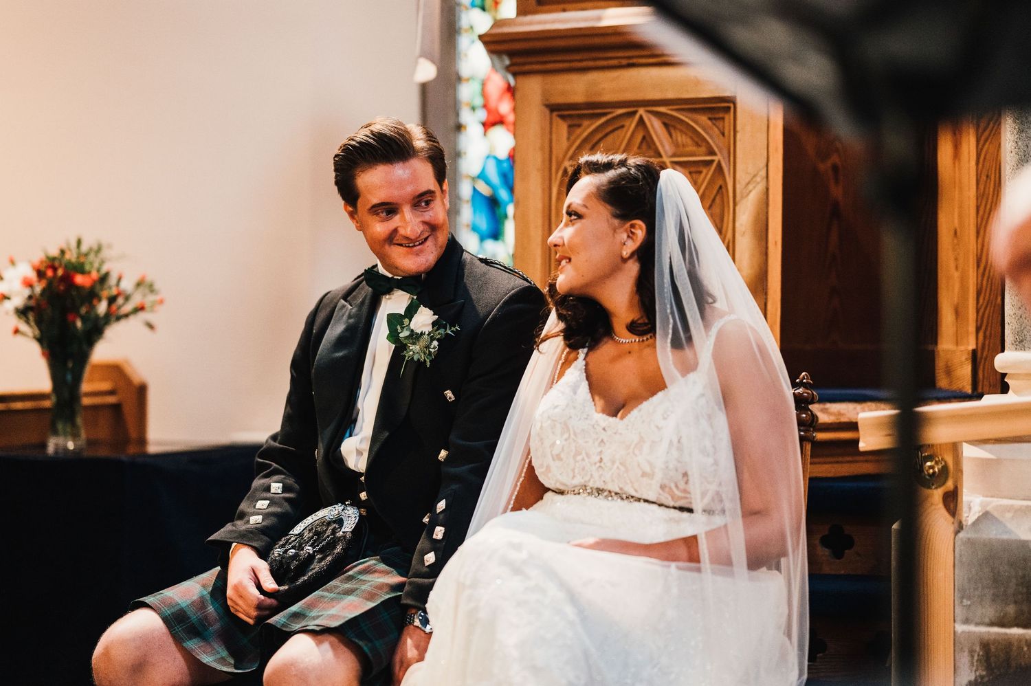 Aberdeen Wedding Photography. Intimate wedding ceremony moments in a warmly lit church setting.