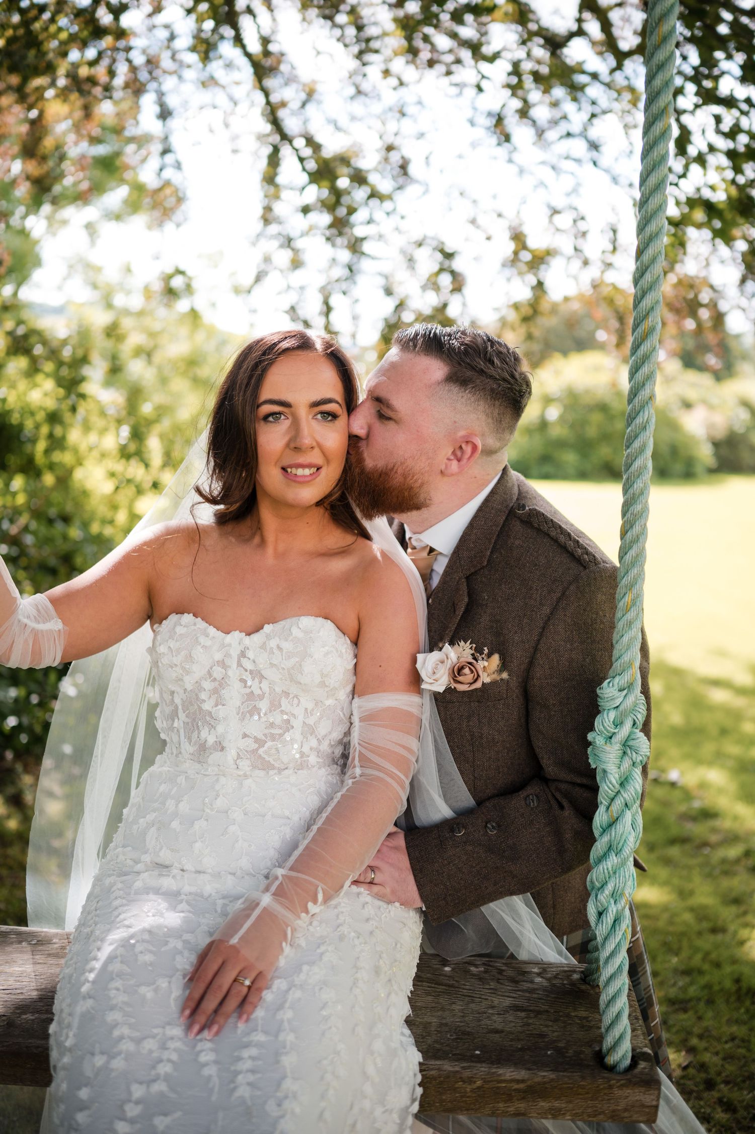 Aberdeen Wedding Photography. Romantic moment captured on a rustic wooden swing in a garden setting.