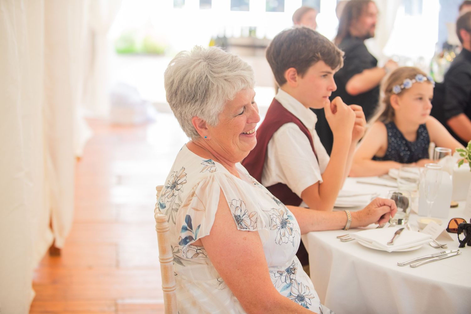 Wedding reception guests seated at tables during dinner service.