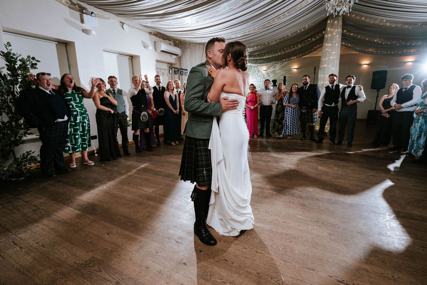 Aberdeen Wedding Photography. Couple shares their first dance in elegant venue with draped ceiling.