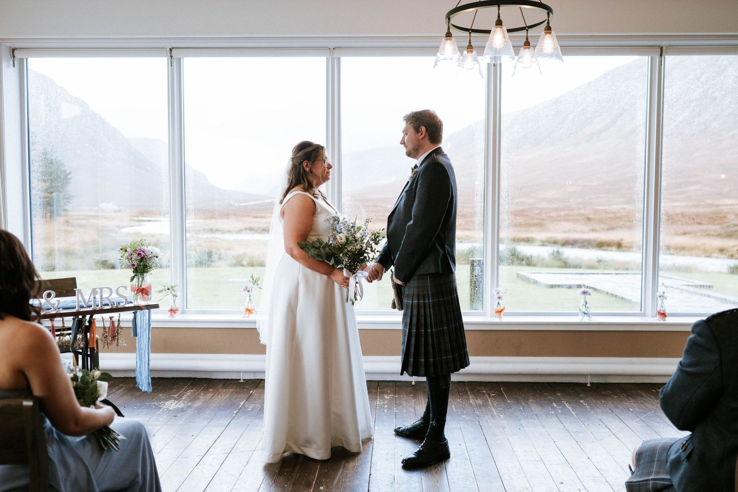 A panoramic sequence of wedding moments captured in a bright modern venue with mountain views through large windows.