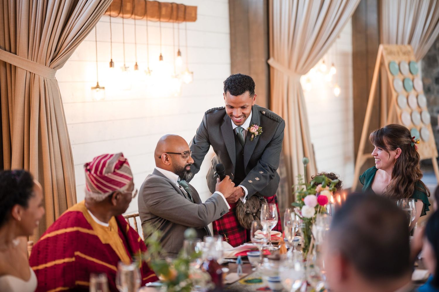 Wedding reception celebration with guests dancing and mingling in an indoor venue.