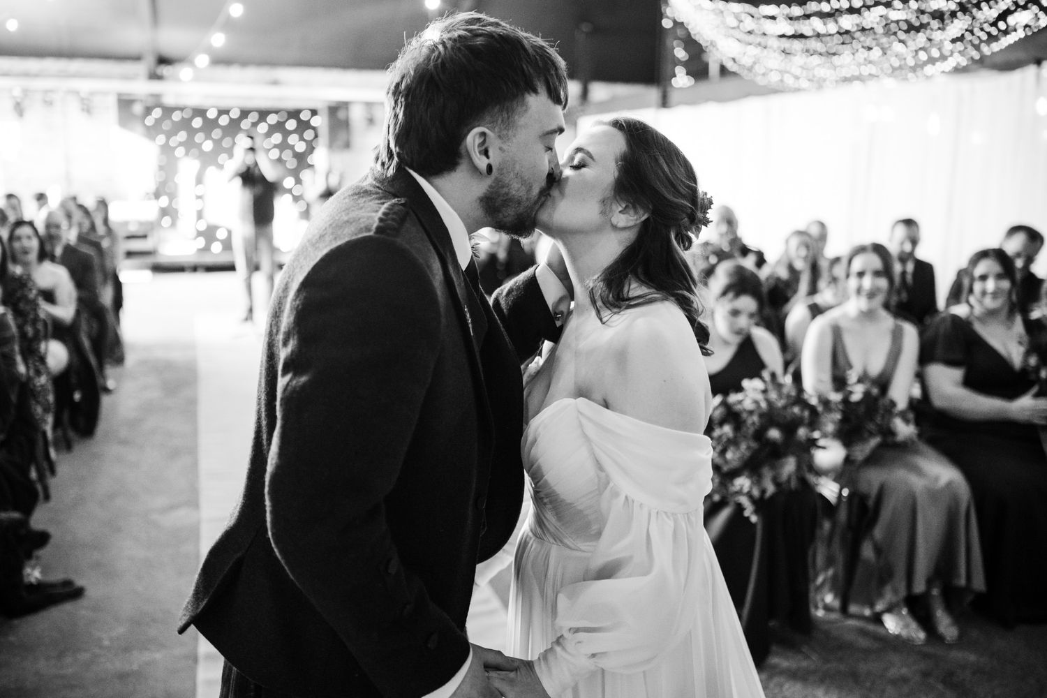 A series of black and white romantic wedding moments showing couples dancing and embracing at a reception.