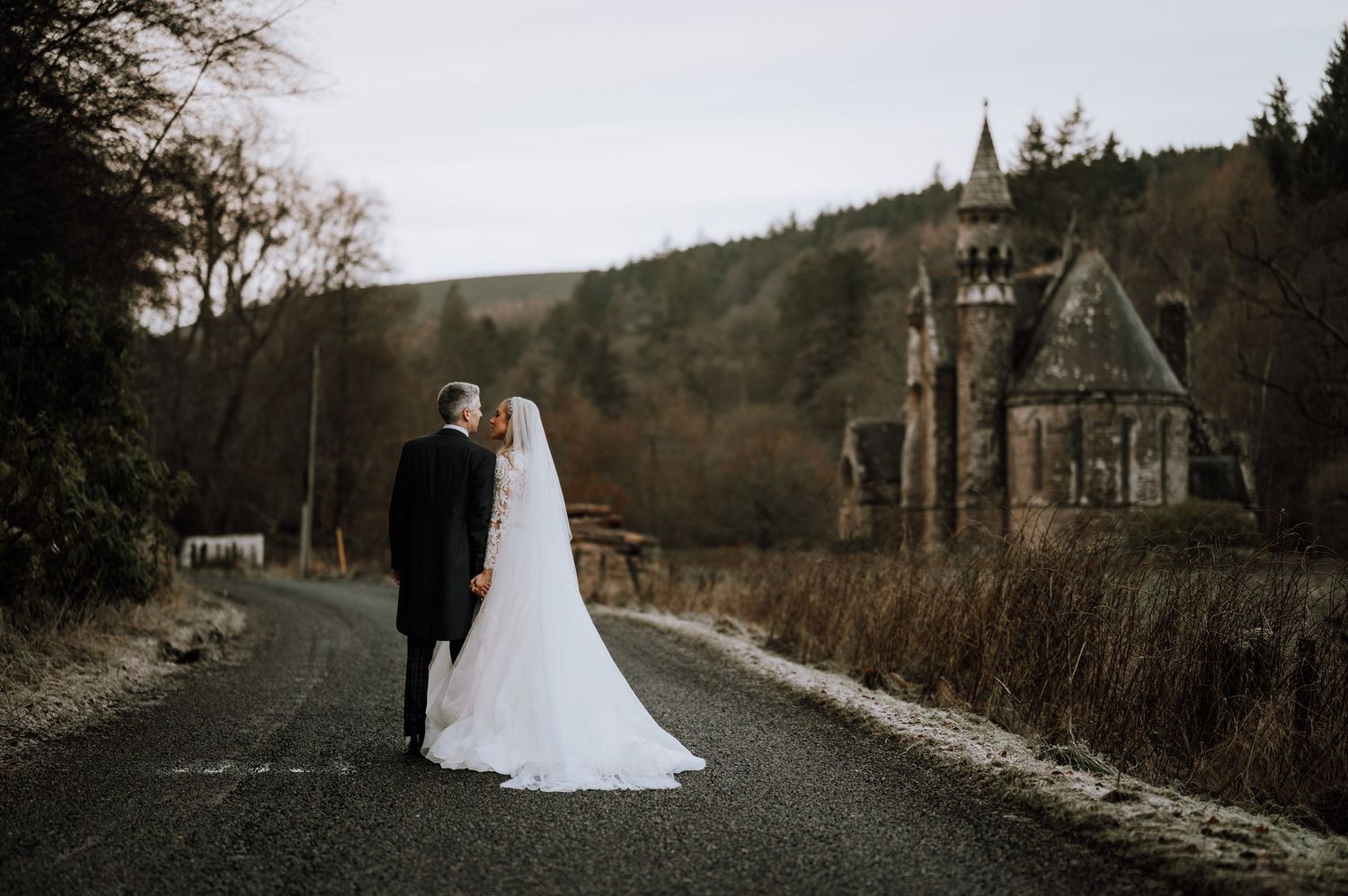 Aberdeen Wedding Photography. A scenic wedding photo shoot on a rural path with rolling hills and church spires in the distance.