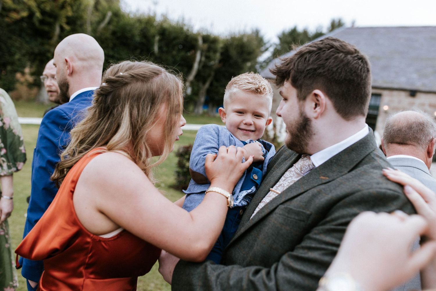 Guests celebrating at an outdoor wedding reception.