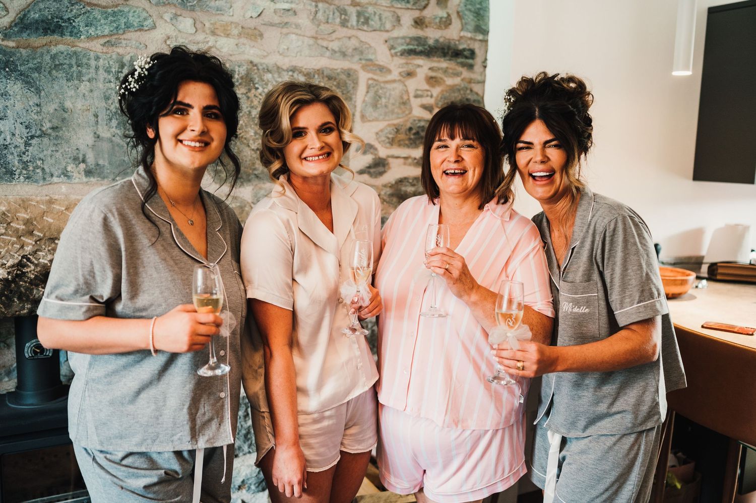 A group wearing coordinated outfits shares joyful laughter in a bright indoor setting.