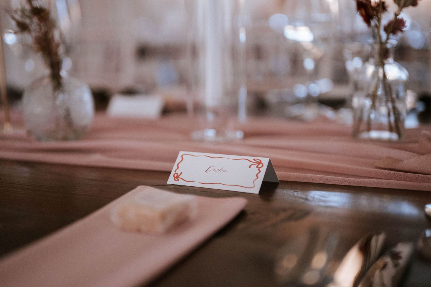 Elegant wedding reception table settings with soft lighting and decorative details.