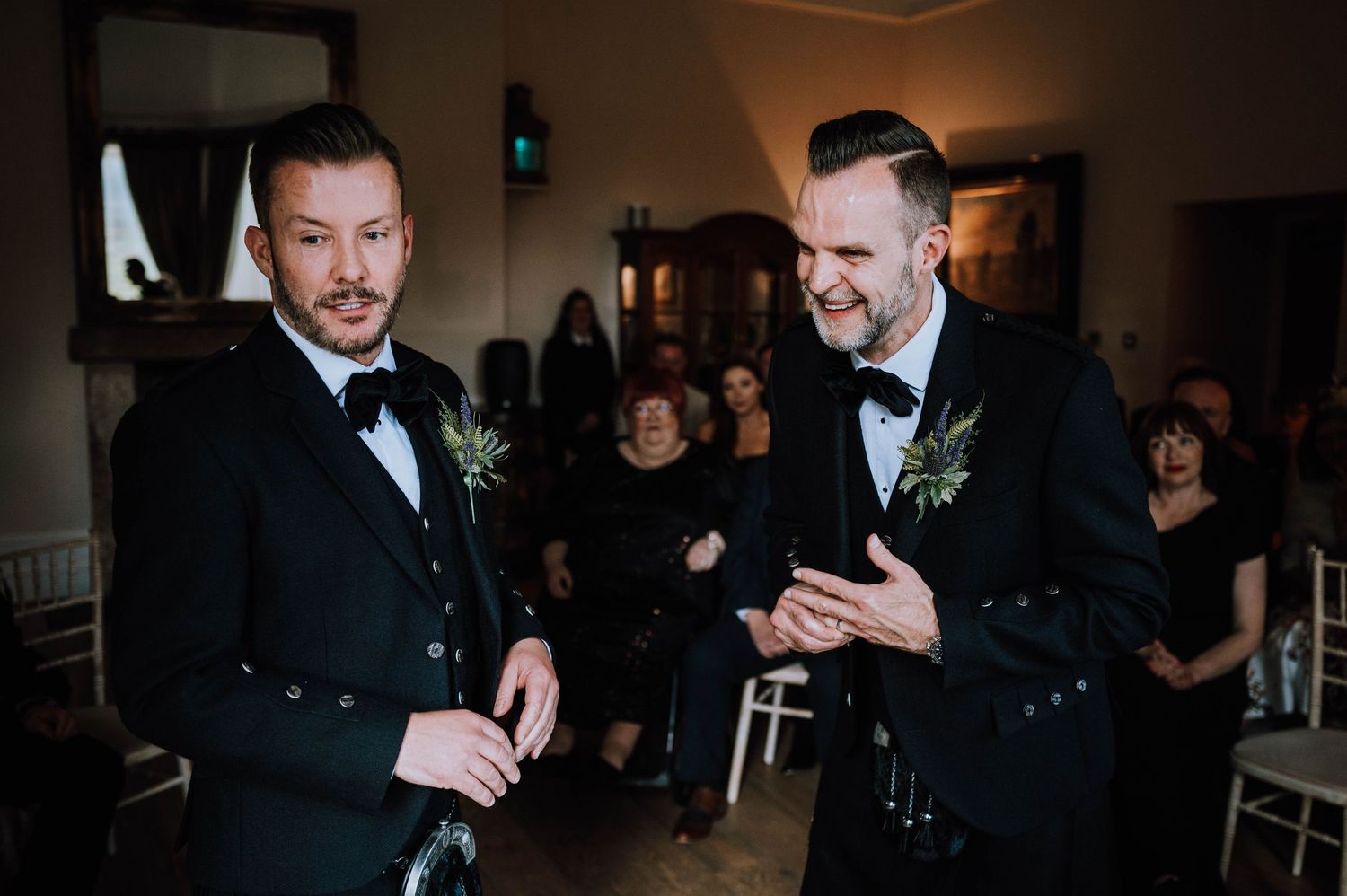 Logie House Wedding Photography. Two people in formal attire share a tender moment during a wedding reception.