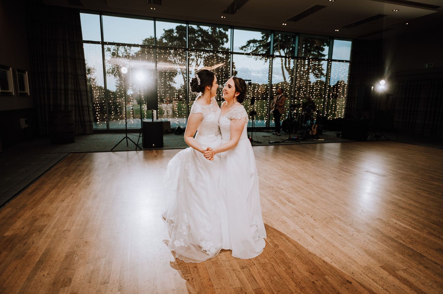 Wedding celebration in a modern venue with wooden floors and large windows Meldrum House Wedding Photography.
