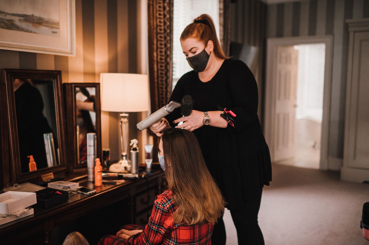 A styling session in a warmly lit vintage-style room with traditional decor.