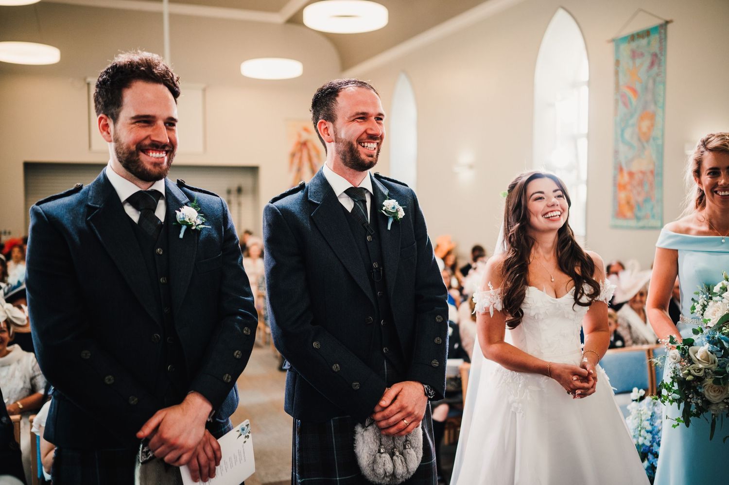 Happy moment captured during wedding ceremony with groomsmen and bridal party at church altar.