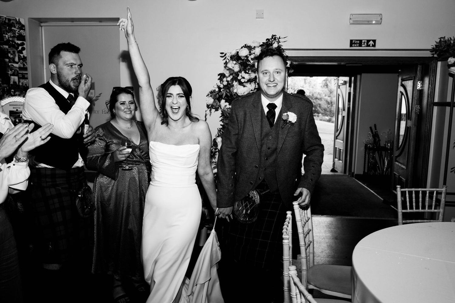 Aberdeen Wedding Photography. Wedding party enters reception venue with joyful celebration.