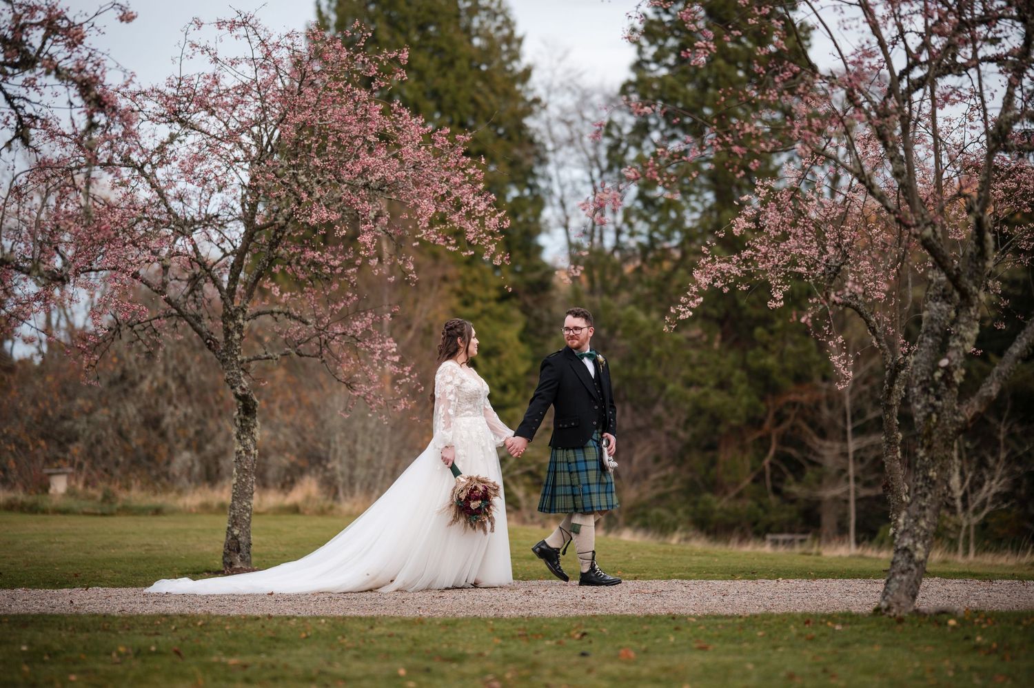 Wedding photo sequence showing couple walking through autumn trees in park setting.