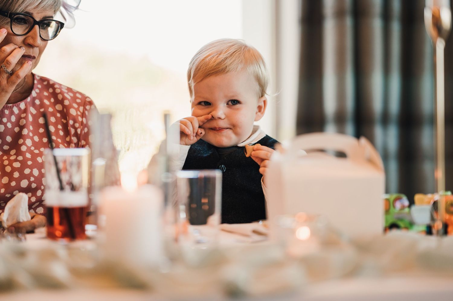 Candid moment during wedding reception dinner with warm ambient lighting.