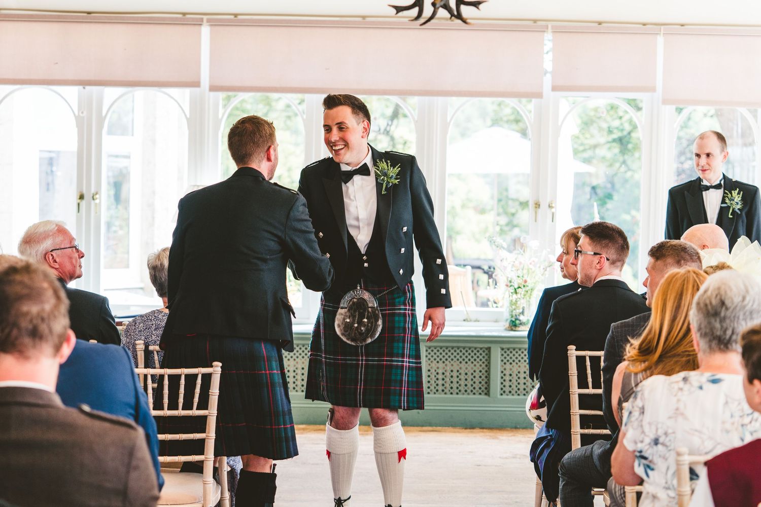 Wedding reception venue with elegant decor and guests mingling.