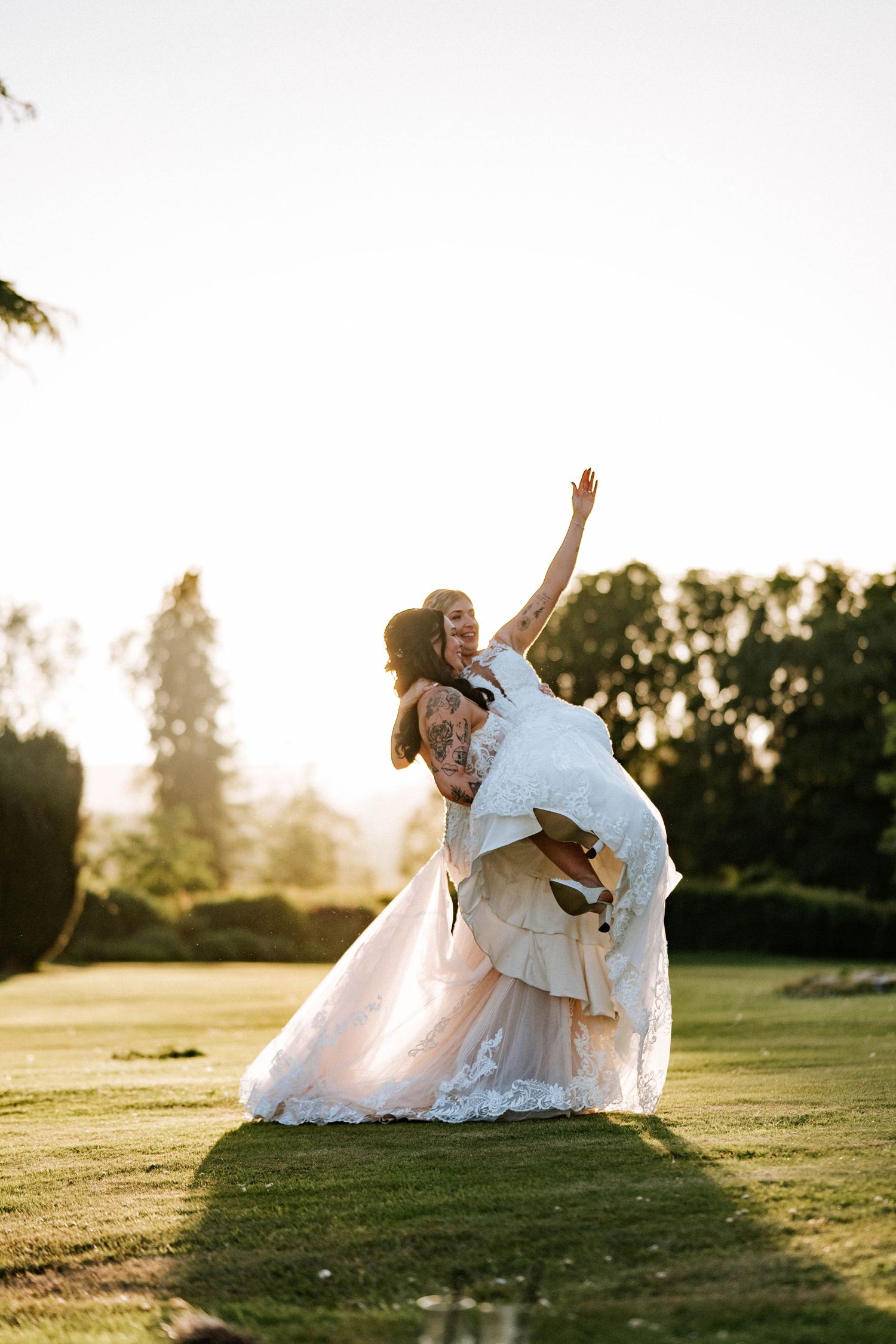 Fasque Castle Wedding Photography. Playful wedding photos taken on a grassy hill during golden hour sunset.