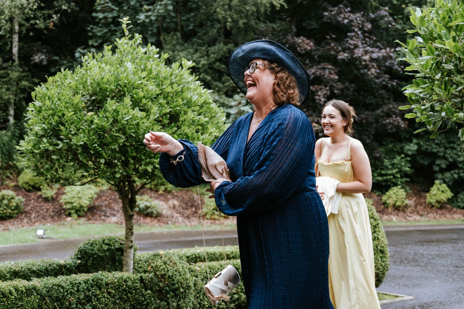 Wedding party enjoying outdoor activities in a scenic garden setting.